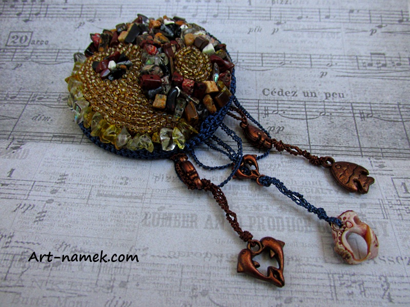Handmade brooch of brown - yellow beads.