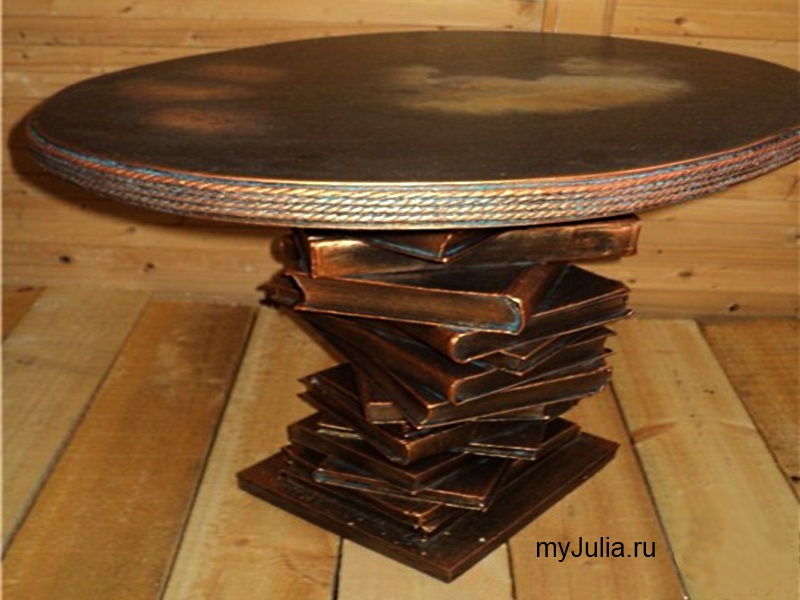 Handmade coffee table with a leg made of books.
